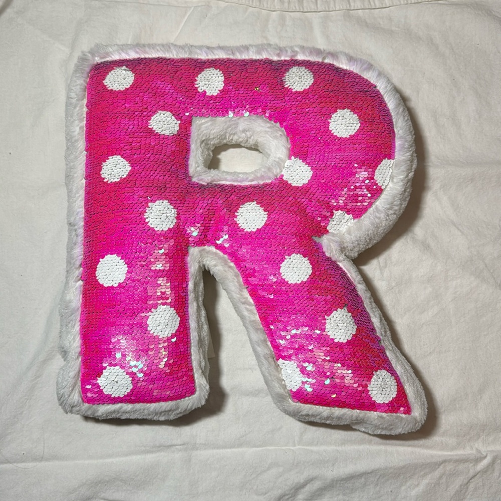 12x12 reversible pink and silver R shaped pillow from Justice